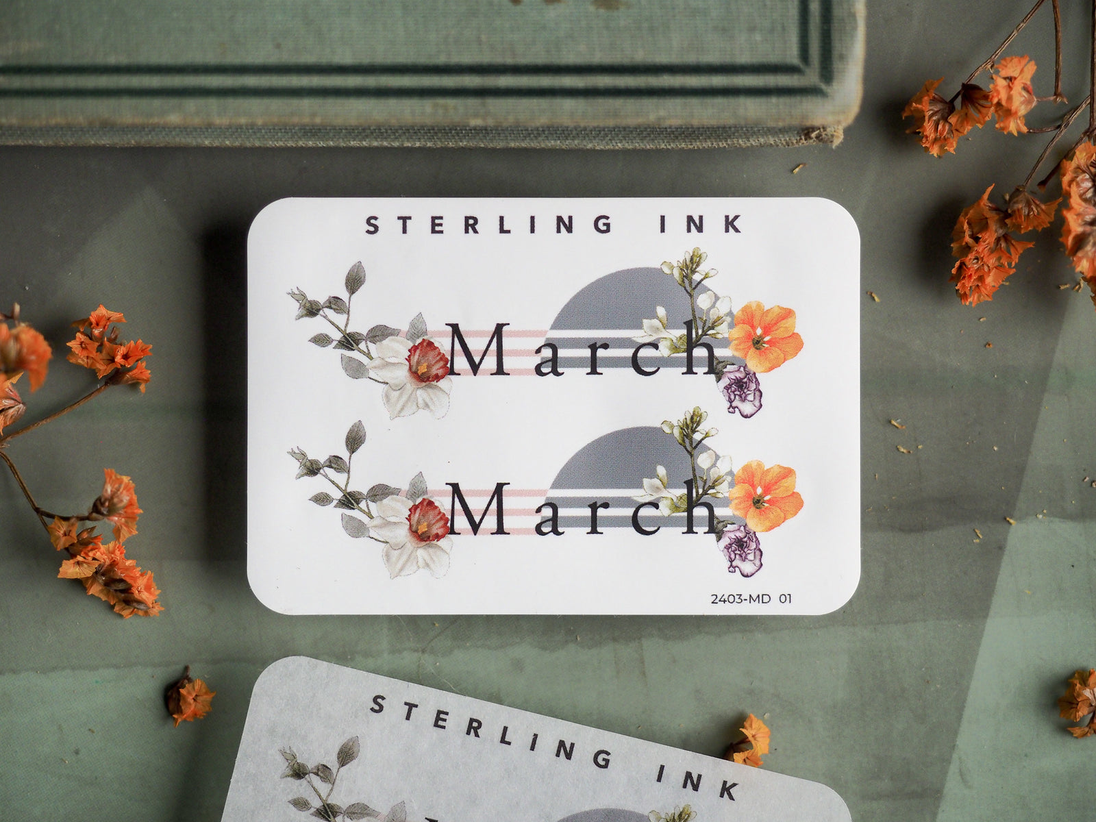 Elegant "March" sticker featuring soft watercolor floral illustrations in shades of blush pink, cream, and purple for seasonal journaling or scrapbooking.