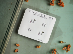 White monthly planning tabs featuring "Sterling Ink" branding and March decals, perfect for organizing a journal or planner.