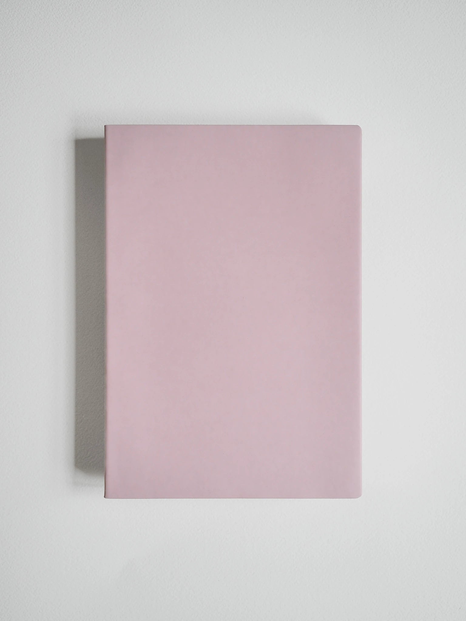 A minimalist, solid dusty pink notebook or journal with a clean, matte finish, shown from a top-down perspective on a light gray background.
#Color_Fairyfloss