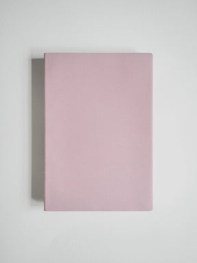A minimalist, solid dusty pink notebook or journal with a clean, matte finish, shown from a top-down perspective on a light gray background.
#Color_Fairyfloss