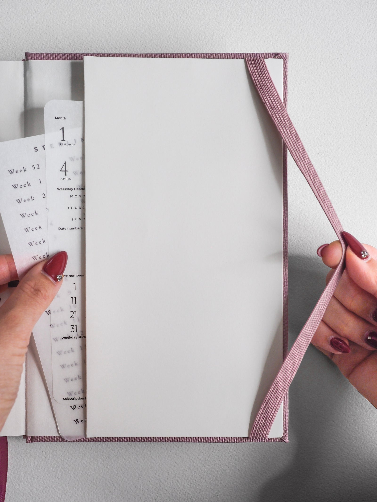 Elegant dusty rose A5 vertical planner featuring structured monthly and weekly layouts for comprehensive 2026 year planning.