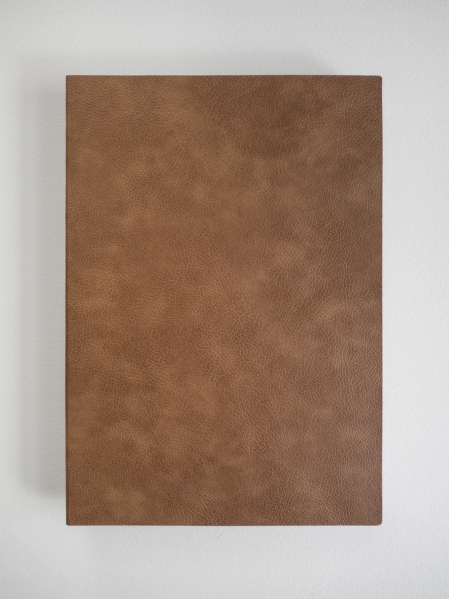 A rectangular brown faux-leather or leather-textured panel with a pebbled grain finish, shown flat against a light gray background.
#Color_Caramel