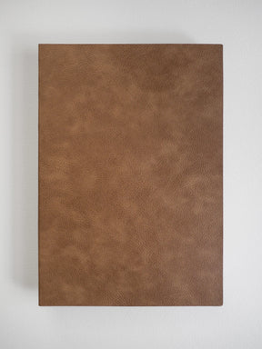 A rectangular brown faux-leather or leather-textured panel with a pebbled grain finish, shown flat against a light gray background.
#Color_Caramel