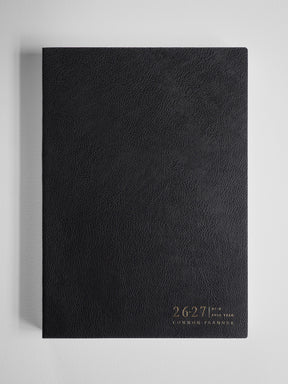 Black, academic B5 planner with a textured cover featuring the debossed years 26-27 and the text "Common Planner."