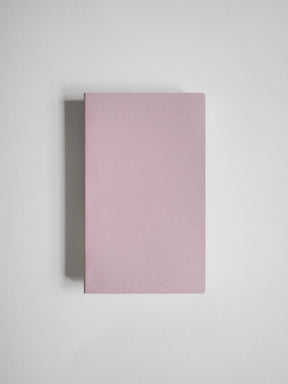 A minimalist, solid dusty pink hardcover notebook or journal shown from a top-down perspective on a light gray background.
#Color_Fairyfloss