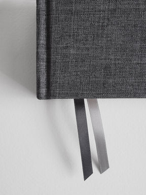 Sophisticated B6 planner featuring a textured charcoal gray cover and a set of coordinating dual ribbon bookmarks.