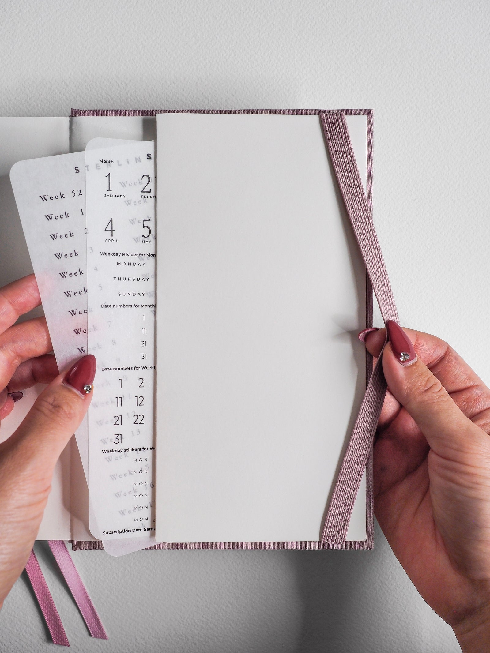 B6 vertical 2026 common planner featuring full-year monthly and weekly layouts with soft pastel pink accents for organized scheduling.