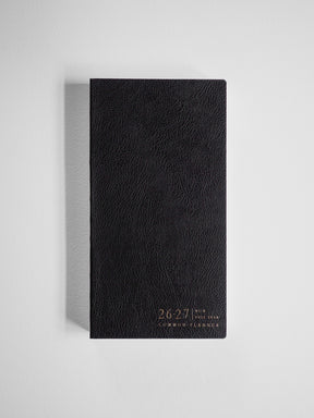 Black, textured academic planner cover for the 2026-2027 full year, featuring elegant gold lettering identifying the Common Planner branding.