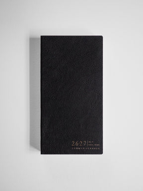 Textured black academic planner for the 2026-2027 school year, featuring elegant embossed gold lettering identifying it as the Common Planner.