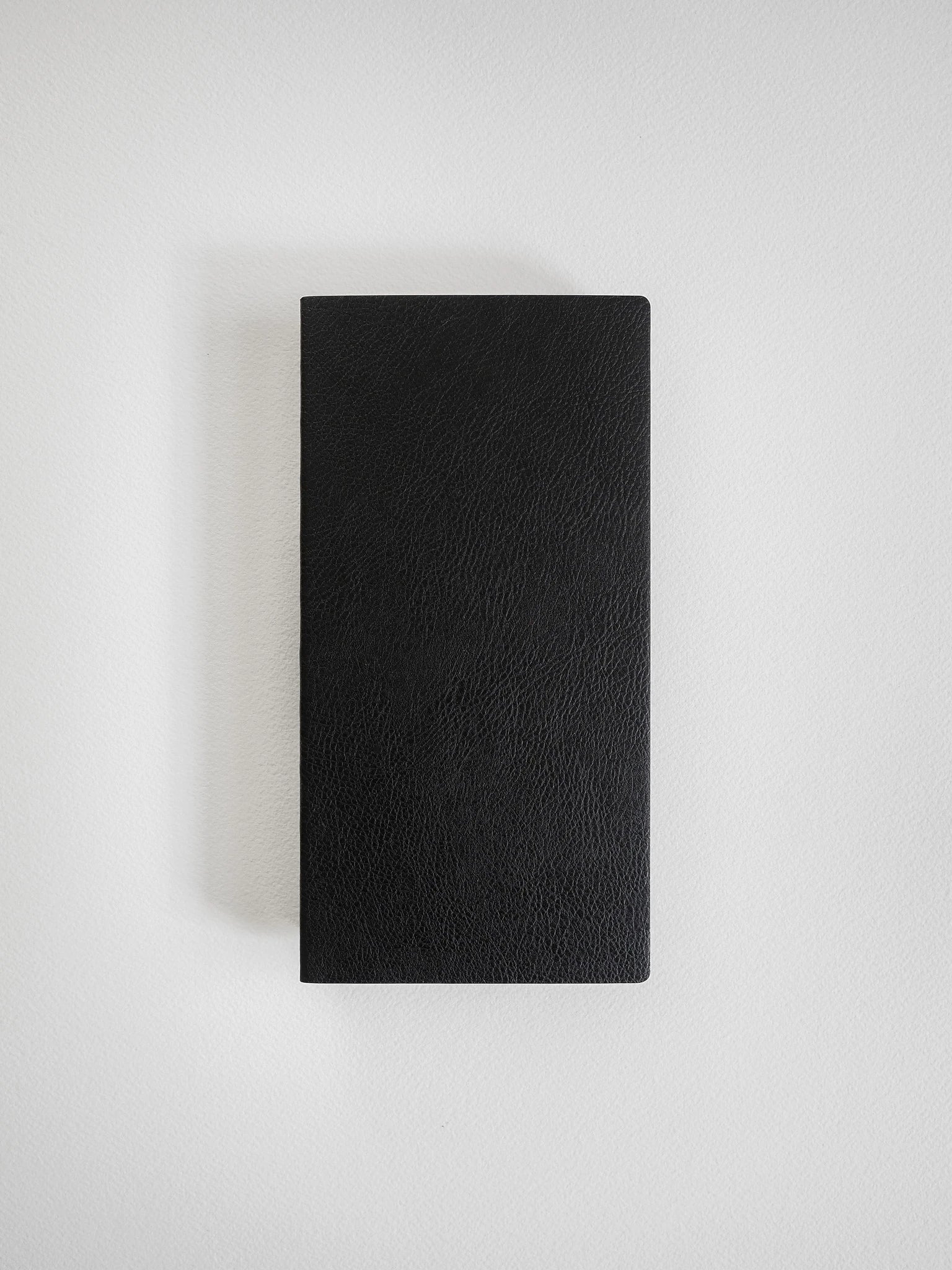 A black textured leather notebook or journal with a rectangular shape, shown flat against a light gray background.
#Color_Onyx