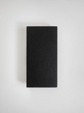 A black textured leather notebook or journal with a rectangular shape, shown flat against a light gray background.
#Color_Onyx