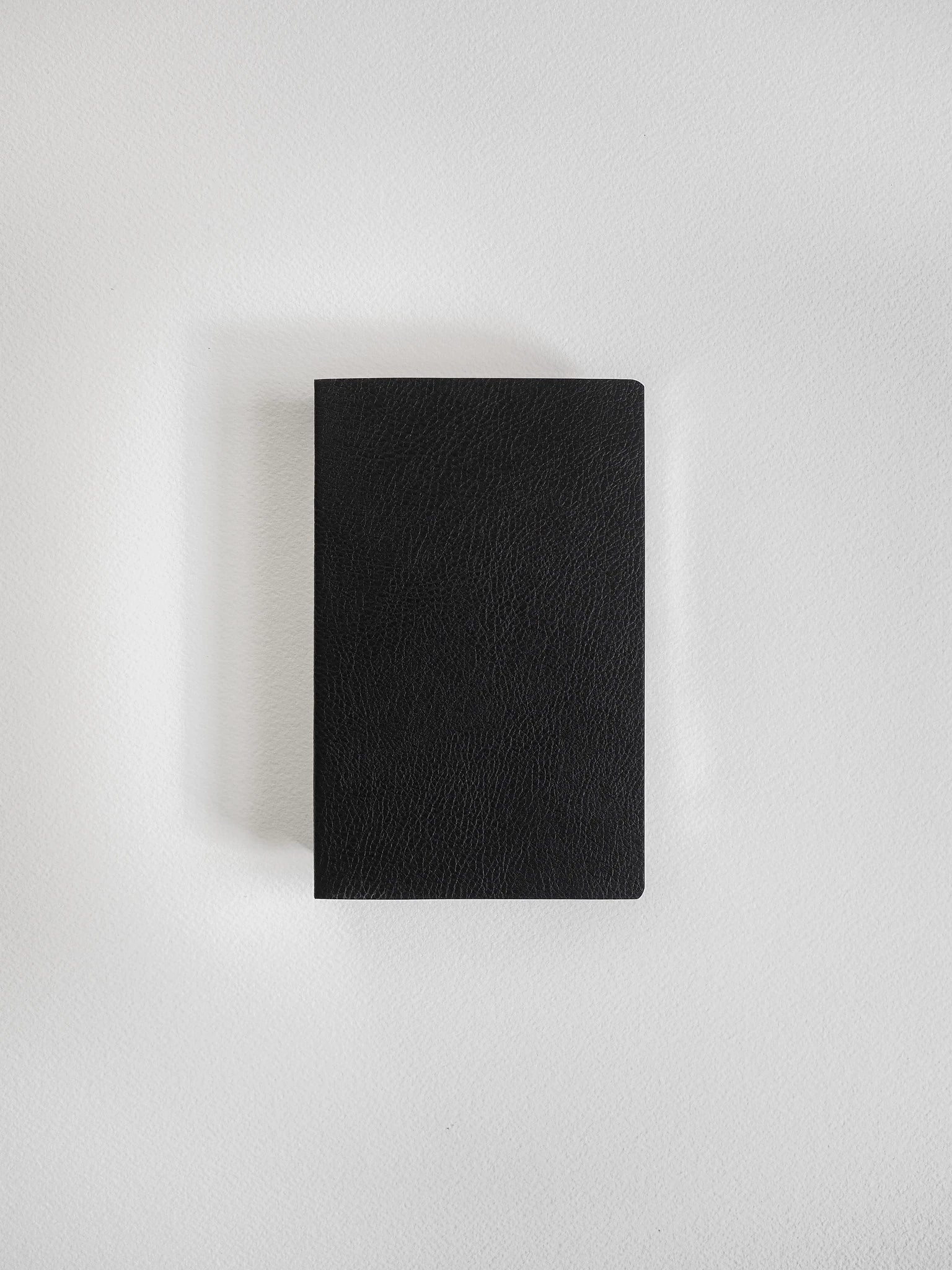 A black textured leather notebook or journal with a rectangular shape, centered on a light gray background.
#Color_Onyx