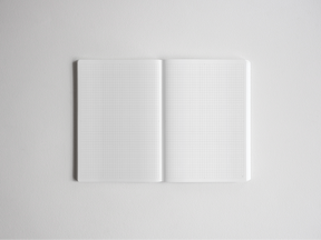 An open B6 notebook displaying fine, light-gray graph paper lines across both pages, perfect for academic plotting, grid drawing, or organized note-taking.