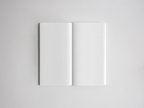Open notebook displaying 272 pages of graph paper featuring precise, uniform light gray grid lines, ideal for detailed note-taking, drawing, or study planning.
