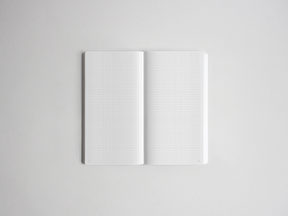 Open spiral-bound notebook showing two pristine pages covered in uniform, precise graph paper grids, perfect for technical notes or drawing.
