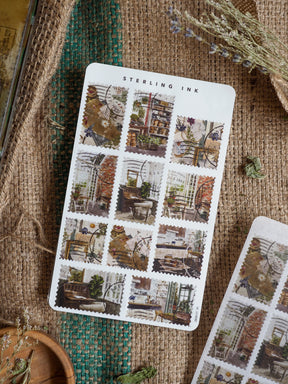 Sterling Ink sticker set featuring a grid of vintage architectural stamps with detailed, antique illustrations of historic street scenes and charming shop interiors.
