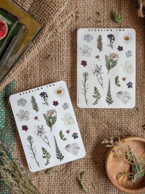 Botanical "Elements" sticker sheets featuring detailed black-and-white illustrations of diverse spring flowers, ferns, leaves, and stems.