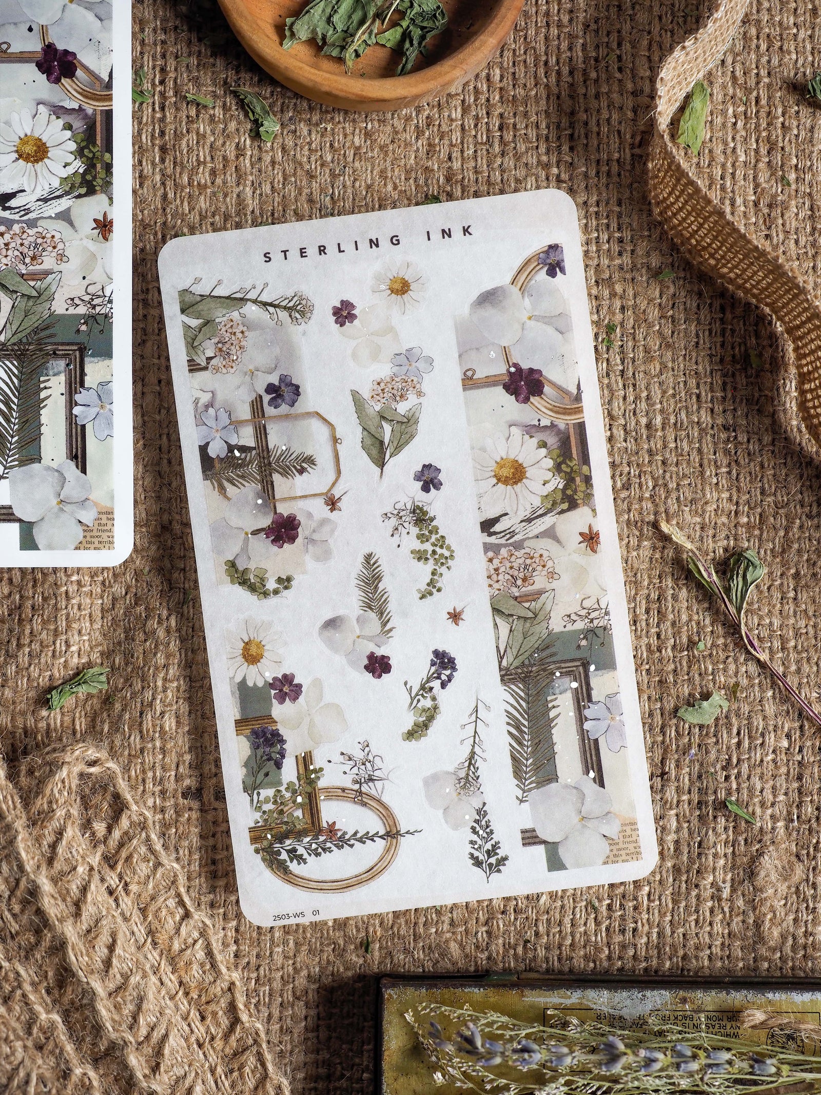 Spring-themed washi sticker set featuring delicate botanical illustrations, soft daisies, and greenery framed with elegant silver foil accents for journaling.