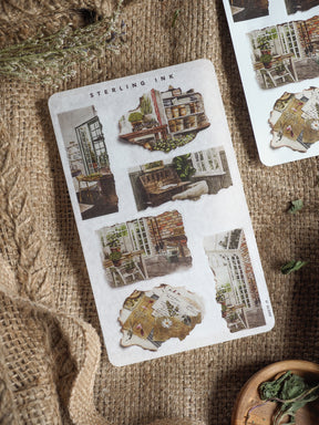 Vintage "Torn Paper Stickers - March 2025" sheet featuring distressed, rustic designs and detailed illustrations of historical urban architecture.