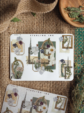 Elegant botanical sticker sheet with silver foil edges and corners, featuring delicate watercolor wildflowers and muted greenery designs perfect for journaling.