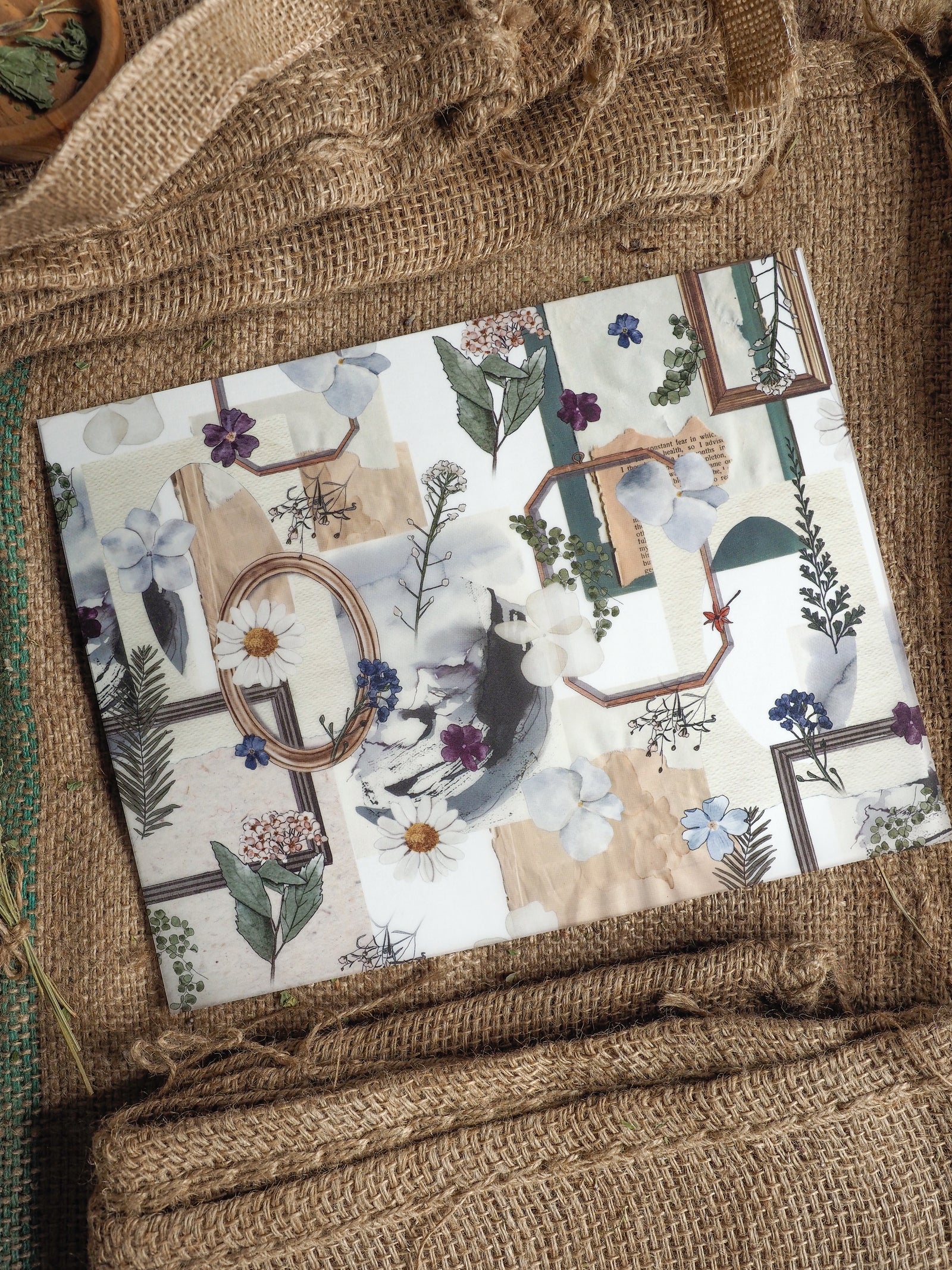 Muted botanical planner cover featuring a delicate collage of watercolor florals, sketch elements, and rustic, earthy-toned frames.