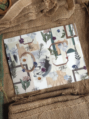 Muted botanical planner cover featuring a delicate collage of watercolor florals, sketch elements, and rustic, earthy-toned frames.