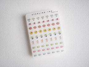 Cute watercolor sticker sheet featuring mini cupcakes, donuts, potted plants, and sweet pastries in a pastel, cottagecore