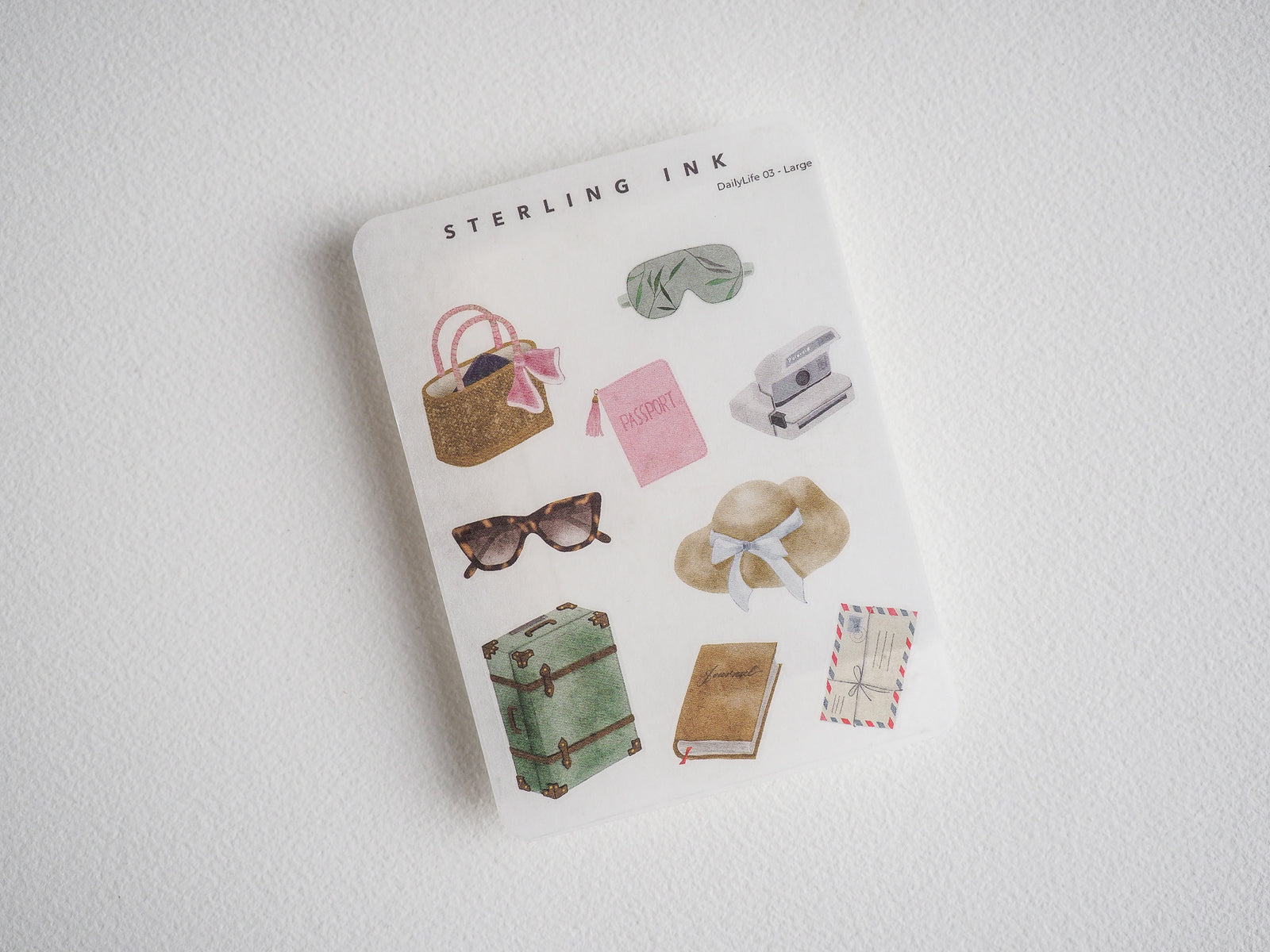 Vintage travel sticker collection: luggage, passport, sunglasses, sun hat, camera, journal, and stationery items for