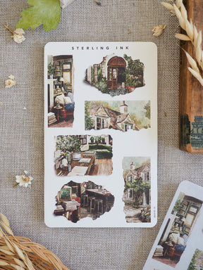 Sheet of vintage torn paper stickers featuring rustic illustrations of cottages, antique bookshelves, and detailed architectural sketches.