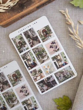Decorative sheet of 'Stamps Stickers - March 2026' featuring vintage illustrations of charming old-world storefronts, bustling urban scenes, and delicate botanical accents.