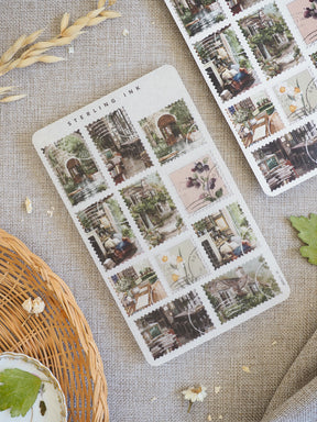 Vintage collection of "Stamps Stickers - March 2026," featuring various square vignettes of charming, overgrown European street scenes and quaint shop fronts.