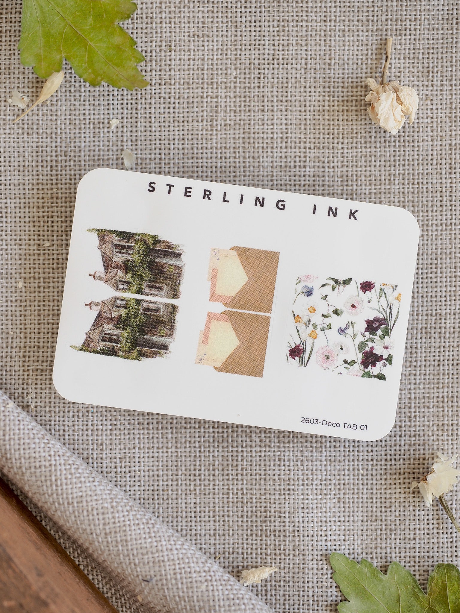 Decorative tab set featuring an ivy-covered cottage motif, a complementary solid tan accent, and a delicate mixed pattern of pastel wildflowers.