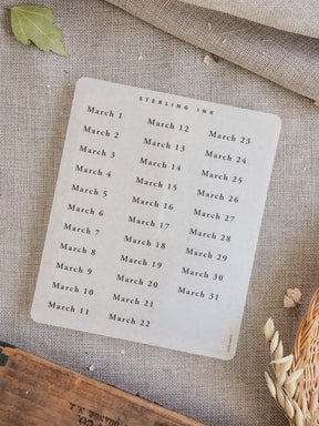 Minimalist white sheet of 'March 2026' date stickers, featuring cleanly printed dates for use in planners and scrapbooking.