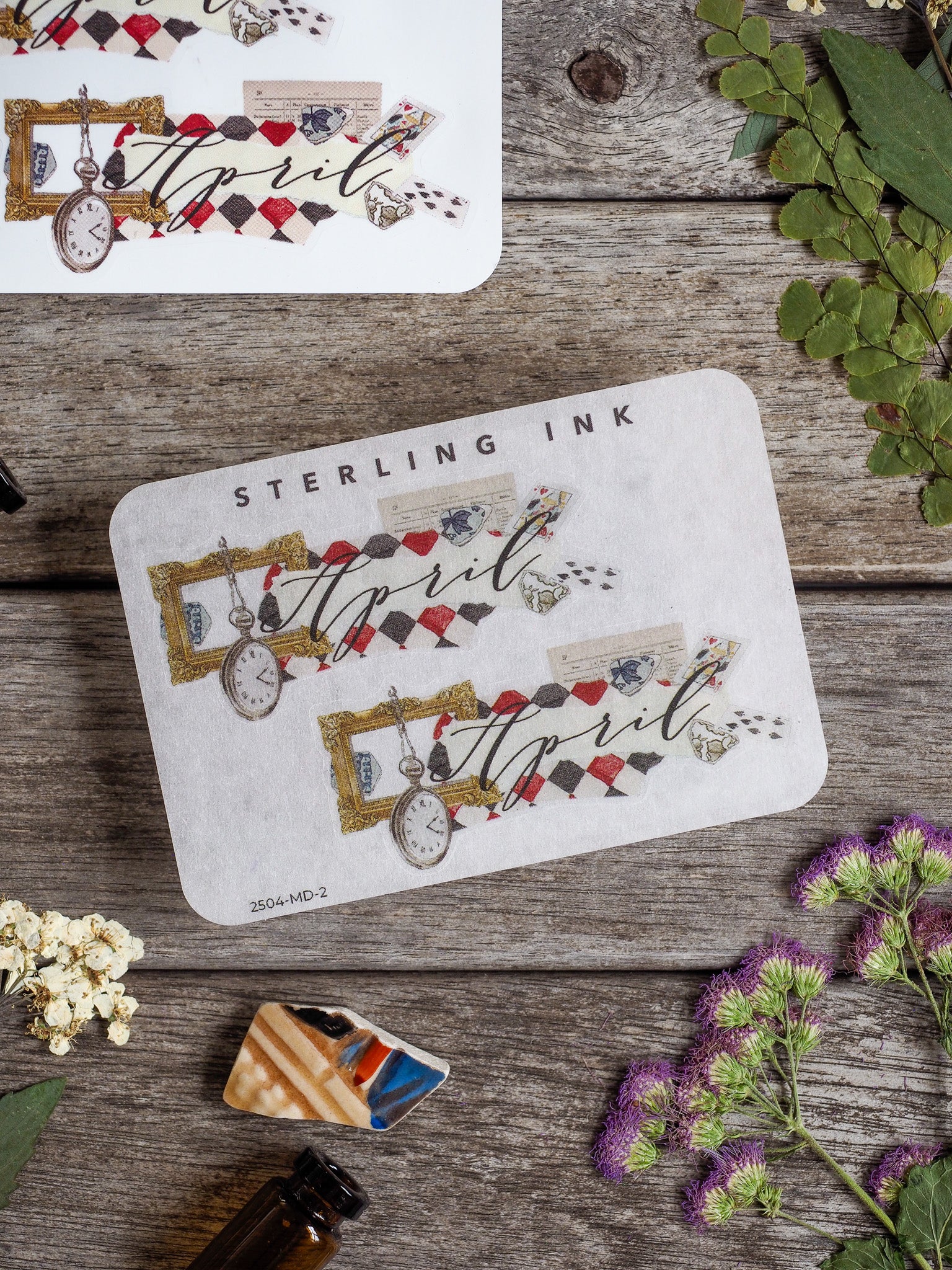 Cream-colored decorative sticker for April, showcasing vintage pocket watches, themed ephemera, and decorative lettering perfect for journaling.