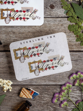 Cream-colored decorative sticker for April, showcasing vintage pocket watches, themed ephemera, and decorative lettering perfect for journaling.