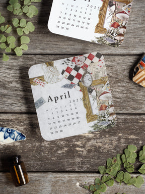 Vintage April 2025 calendar featuring a decorative collage design with checkered patterns, floral illustrations, and antique clock motifs.