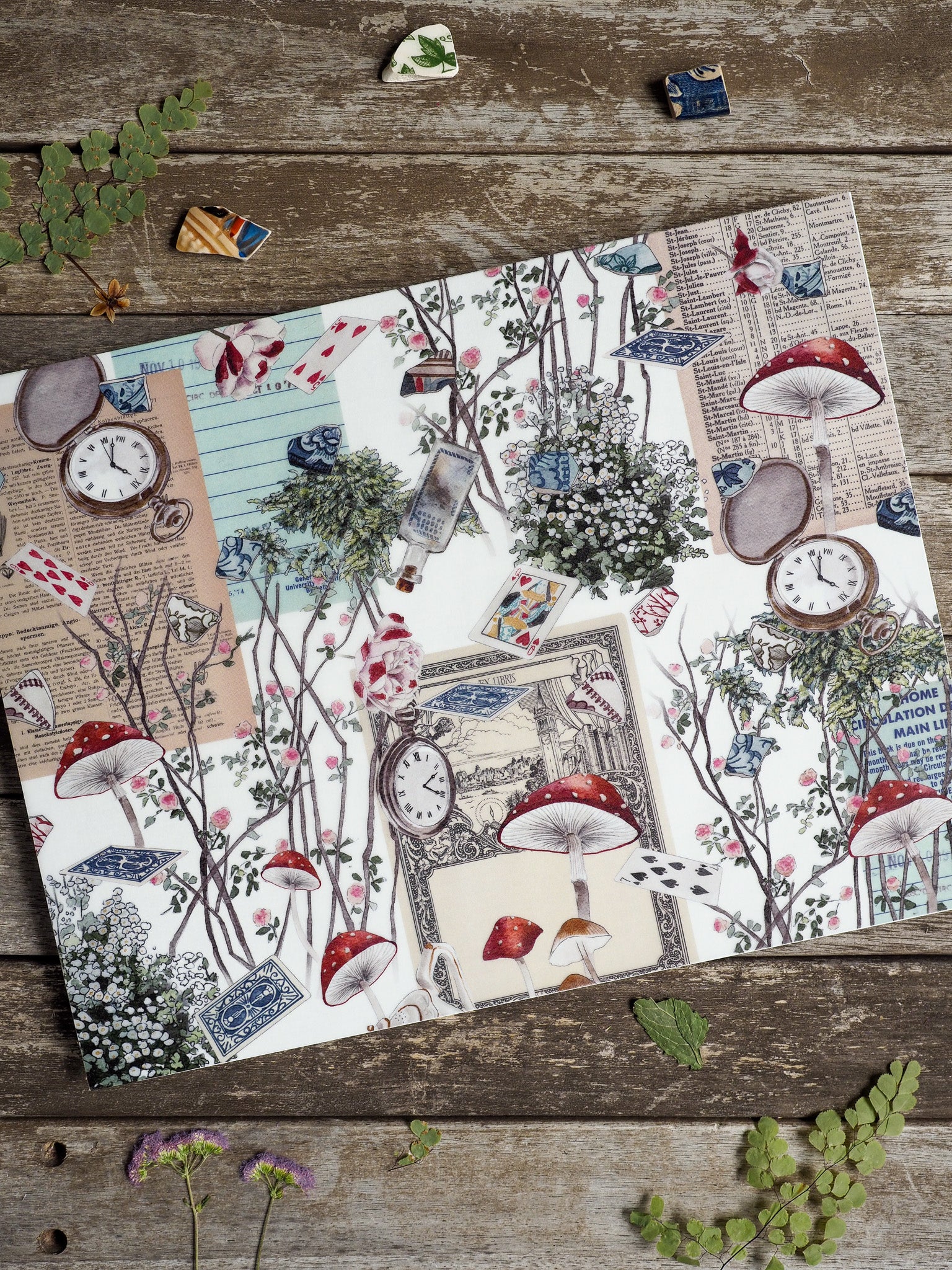 'Vellum - April 2025' planner spread featuring a whimsical collage of stacked antique documents, vintage clocks, and forest toadstools.