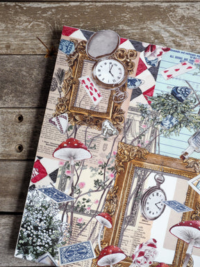 Decorative planner cover featuring a whimsical, vintage collage pattern of red mushrooms, antique pocket clocks, and white floral elements.