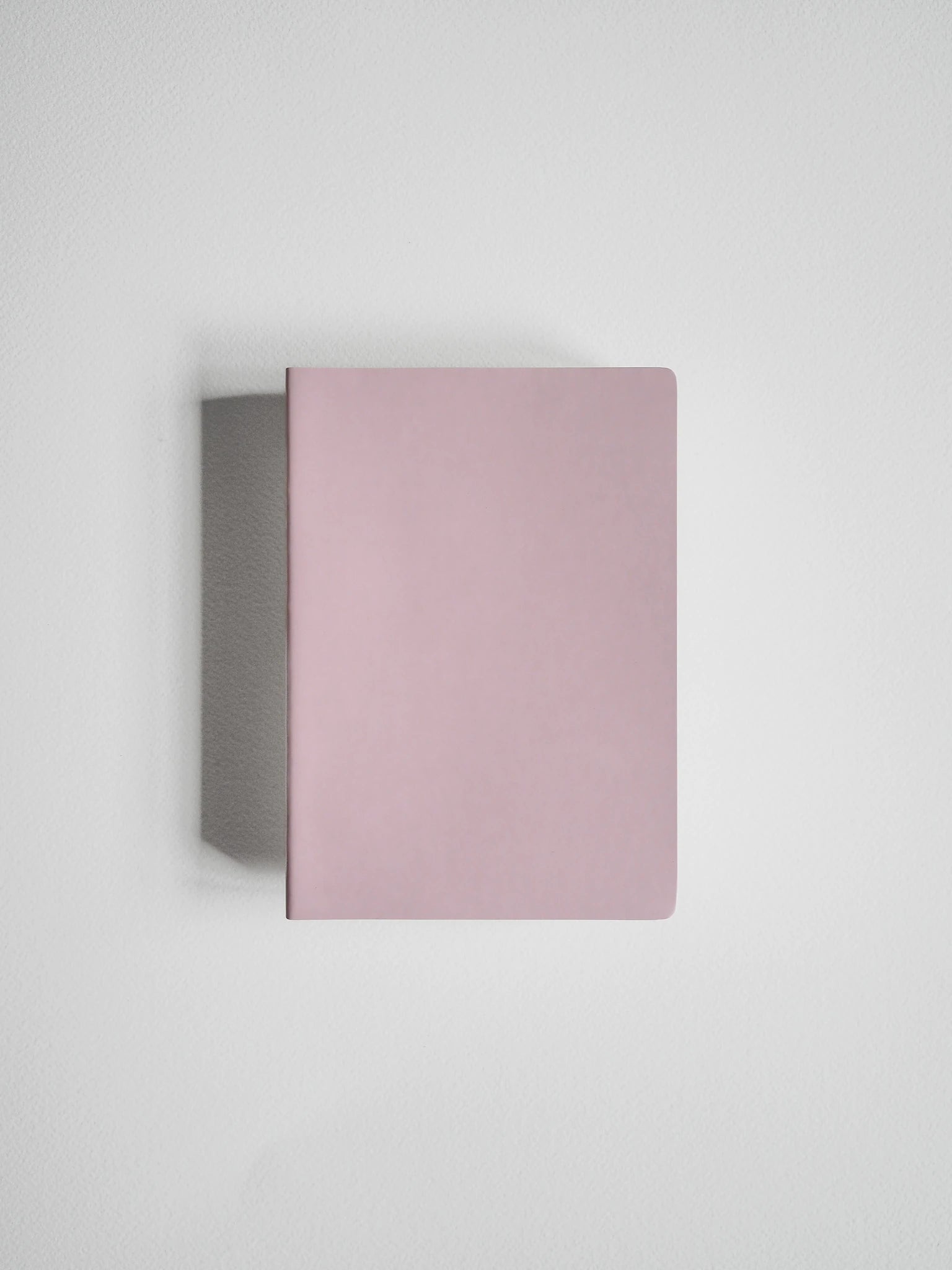 A minimalist, rectangular notebook or journal in a dusty pink color, shown from a top-down perspective on a clean, light gray background.
#Color_Fairyfloss