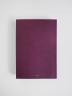 A dark purple notebook with a textured cover and gold foil text at the bottom, displayed on a clean white background.
#Color_Mulberry