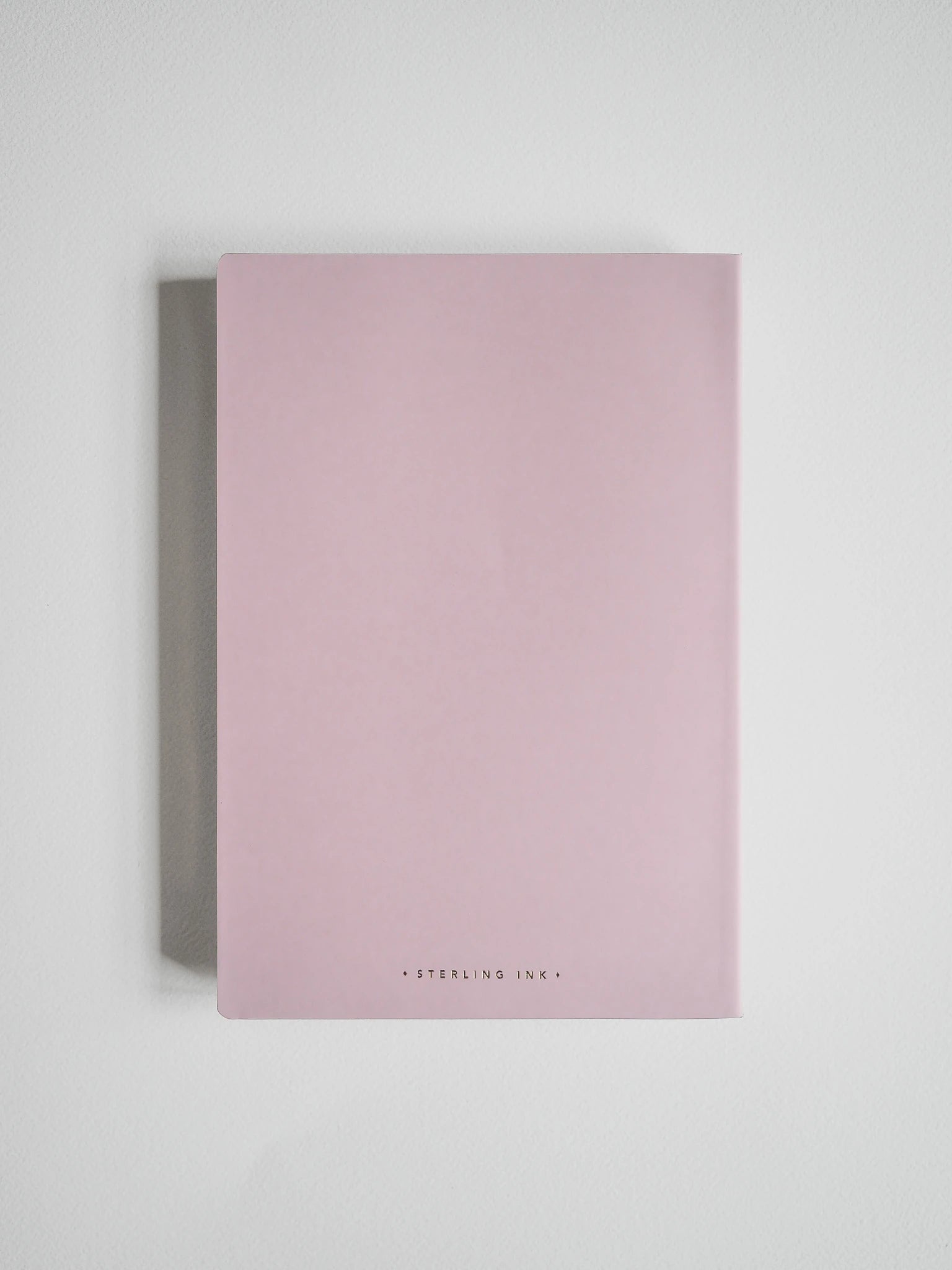 A minimalist pink notebook with a matte finish and gold foil text reading 'STERLING ILK' at the bottom, displayed against a clean white background.
#Color_Fairyfloss