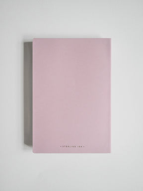 A minimalist pink notebook with a matte finish and gold foil text reading 'STERLING ILK' at the bottom, displayed against a clean white background.
#Color_Fairyfloss