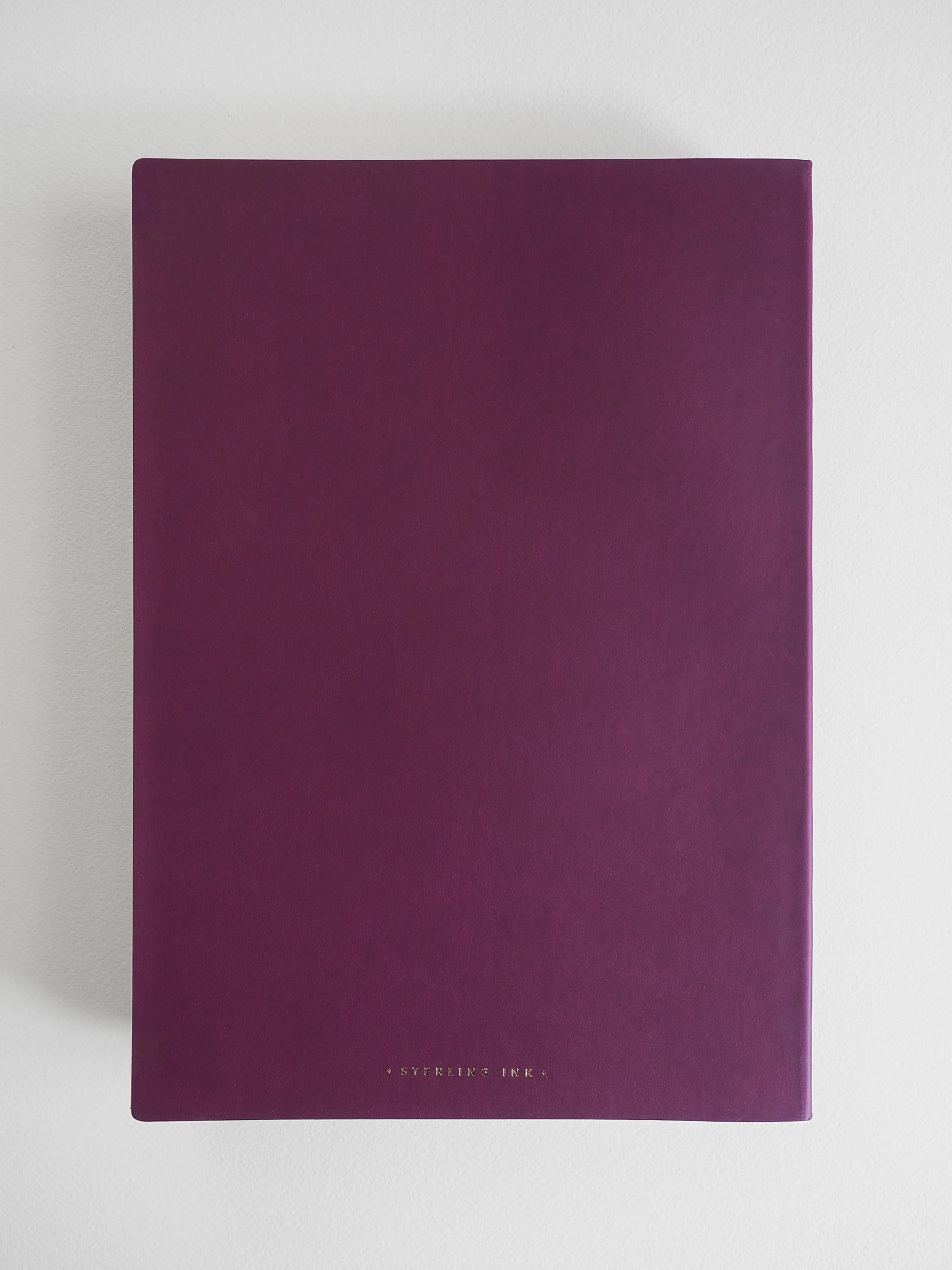 A dark purple notebook with a matte finish and a thin black spine, featuring the brand name 'COPRINTED INK' in small gold lettering at the bottom, set against a light gray background.
#Color_Mulberry