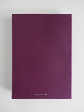 A dark purple notebook with a matte finish and a thin black spine, featuring the brand name 'COPRINTED INK' in small gold lettering at the bottom, set against a light gray background.
#Color_Mulberry