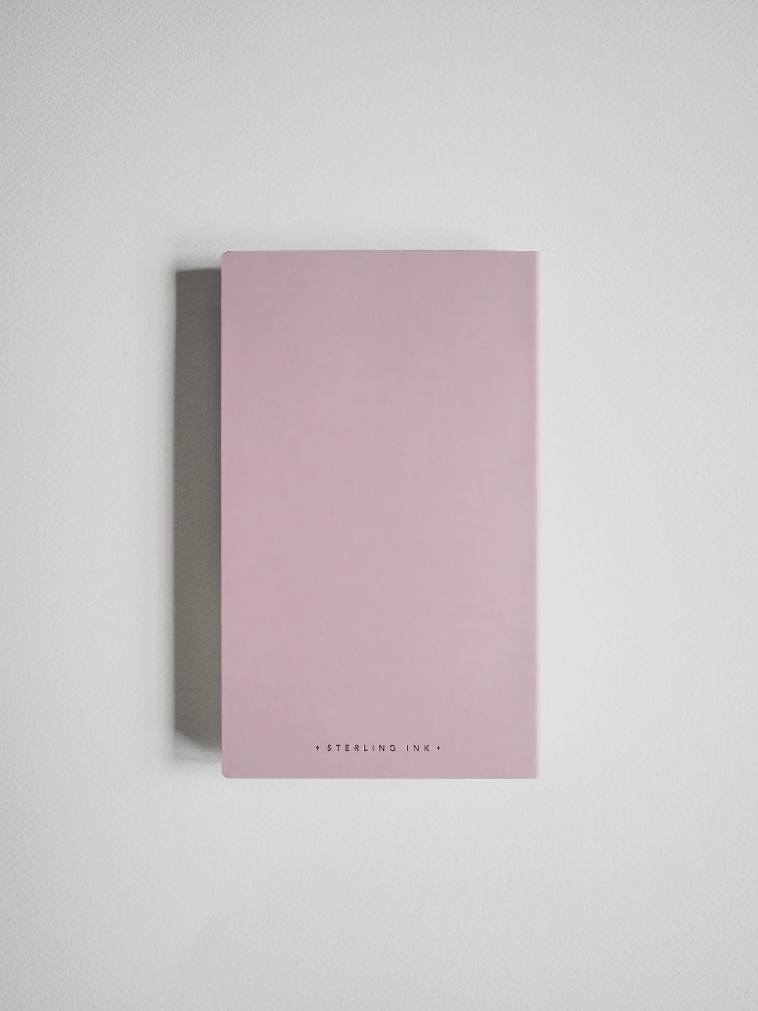 A minimalist pink notebook with 'STERLING INK' printed in small black letters at the bottom, displayed on a clean light gray background.
#Color_Fairyfloss