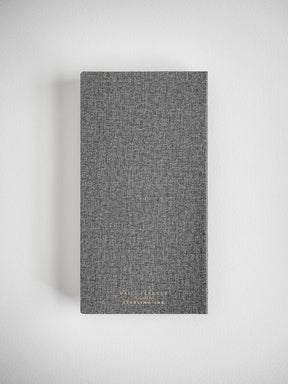 Textured, dark charcoal gray daily planner featuring subtle academic branding for the 2026-2027 academic year.