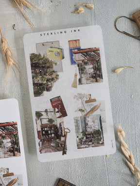 Decorative collage stickers featuring a rustic, vintage aesthetic with layered vignettes of shops, greenery, and natural elements for scrapbooking.