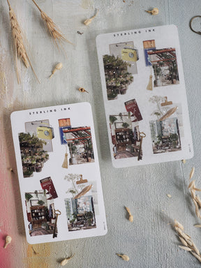 A set of decorative collage stickers featuring silver foil accents and layered photographic scenes of rustic architecture and vintage interiors.