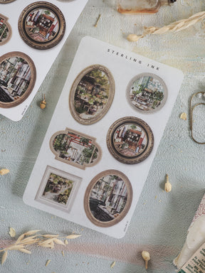 Vintage picture frame stickers featuring ornate, sepia-toned die-cuts of classic city street scenes, perfect for decorating journals or scrapbooks.