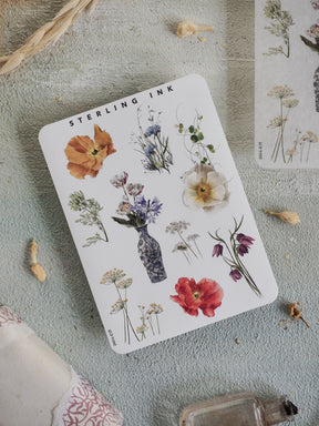 Botanical elements sticker sheet featuring watercolor illustrations of diverse flowers, leaves, and plant studies on a clean white background.